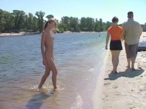 Watch a naked chick at the beach tan her hot body 